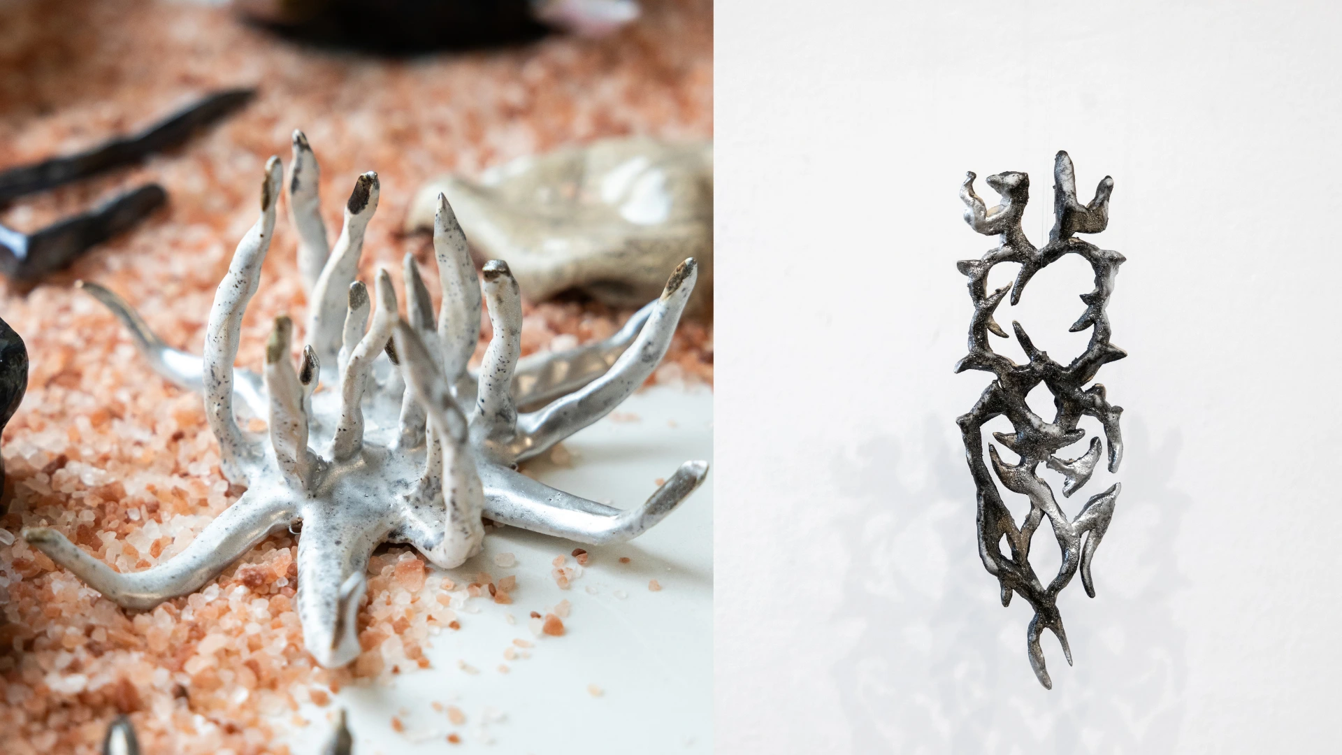 Abstract branching sculptural objects with pale and metallic-looking surfaces arranged against a light architectural background.