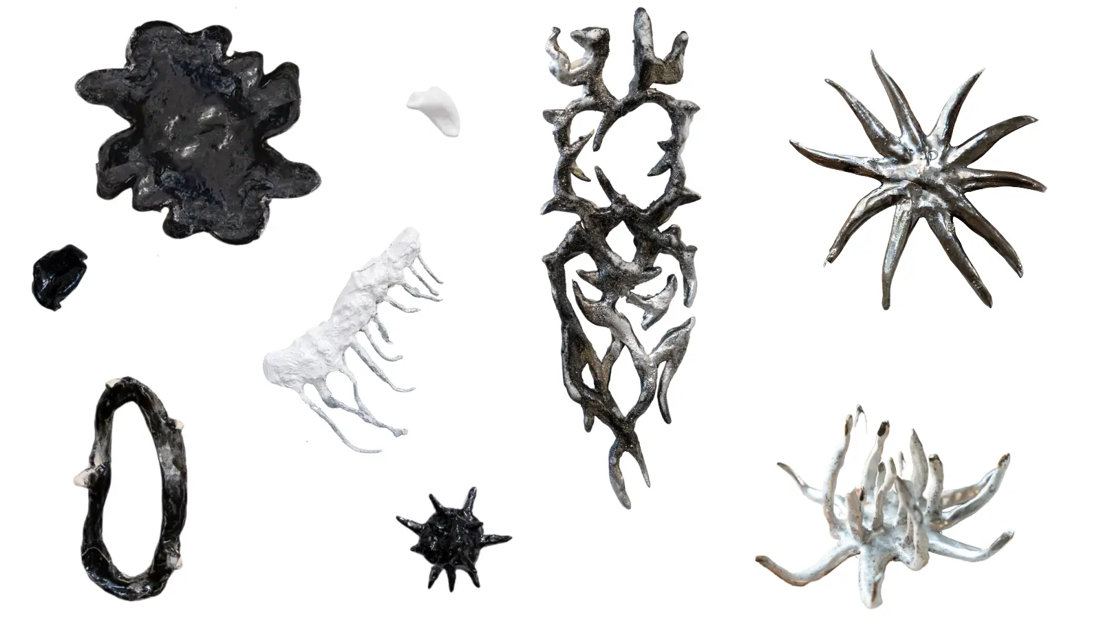 Vertical composition of abstract branching ceramic sculptures displayed against a white background.