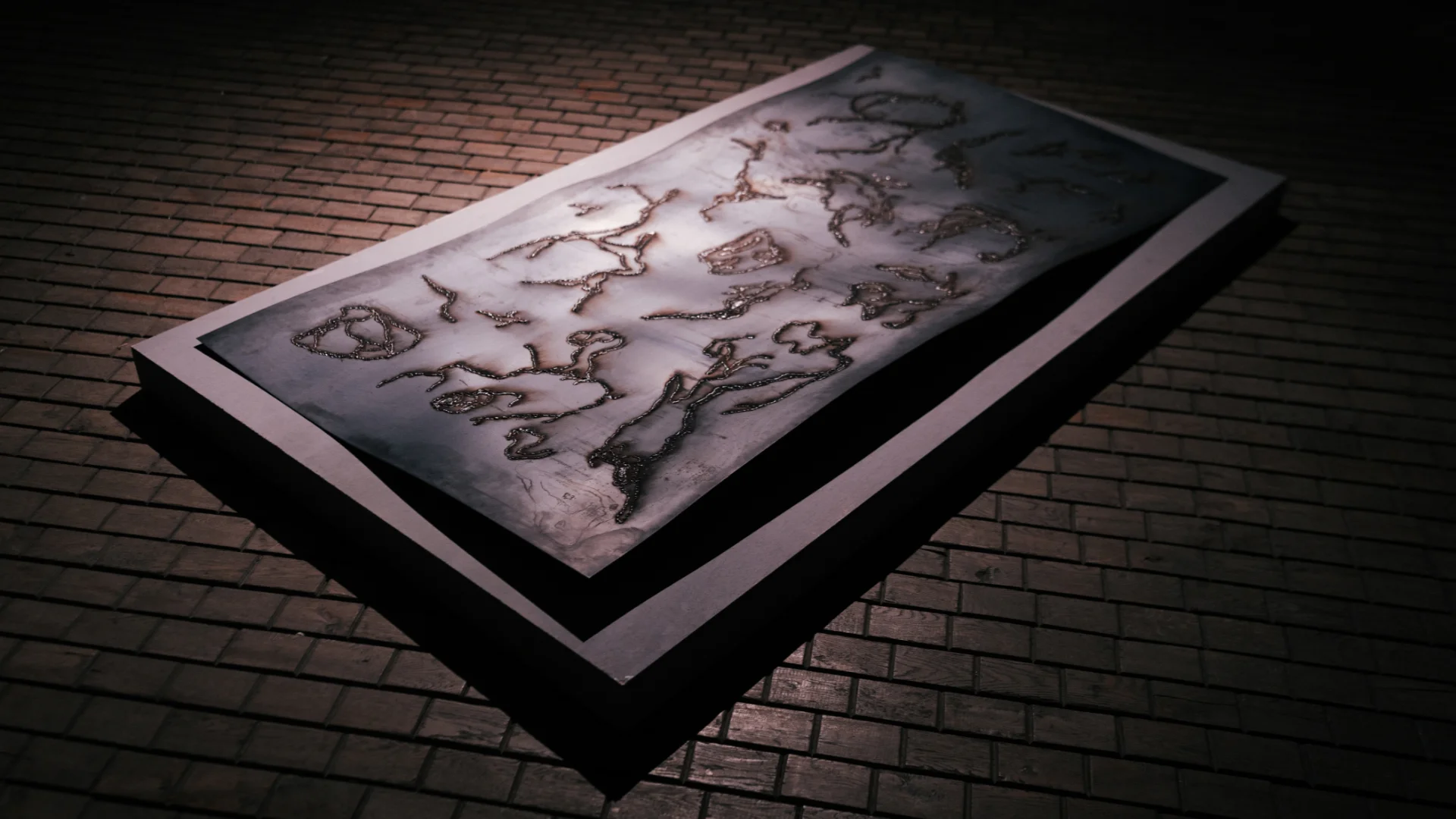 Large dark steel panel with welded abstract patterns displayed at an angle on a brick floor.