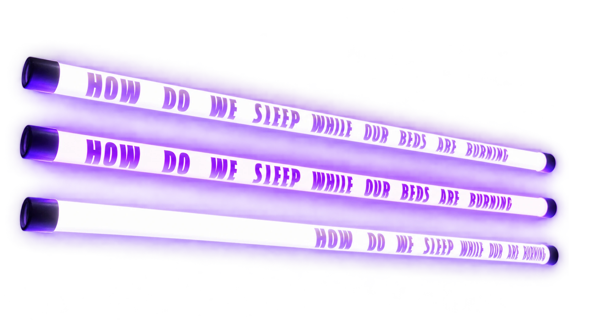 Three glowing white and violet fluorescent tubes featuring the phrase How Do We Sleep While Our Beds Are Burning.